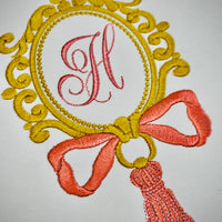 OVAL FRAME WITH TASSEL AND BOW